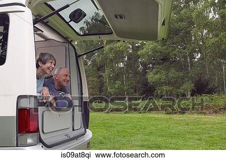 Senior couple lying inside open camper van View Large Photo Image Stock Image - Senior couple lying inside open camper van. Fotosearch