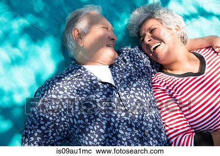 Senior couple lying together on picnic blanket, elevated view View Large Photo Image Stock Image - Senior couple lying together on picnic blanket, elevated view. Fotosearch