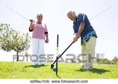 Senior couple playing croquet, outdoors View Large Photo Image Stock Image - Senior couple playing croquet, outdoors. Fotosearch