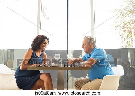 Senior man and wife playing chess and drinking wine View Large Photo Image Picture - Senior man and wife playing chess and drinking wine. Fotosearch