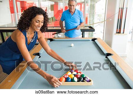Picture - Senior man and wife setting up pool table. Fotosearch