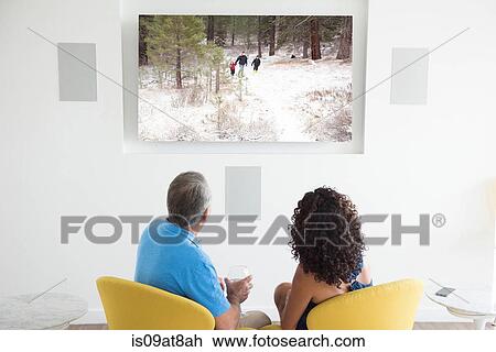 Senior man and wife watching family photographs on digital screen View Large Photo Image Stock Image - Senior man and wife watching family photographs on digital screen. Fotosearch