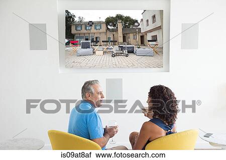 Senior man and wife watching photographs on digital screen View Large Photo Image Stock Image - Senior man and wife watching photographs on digital screen. Fotosearch