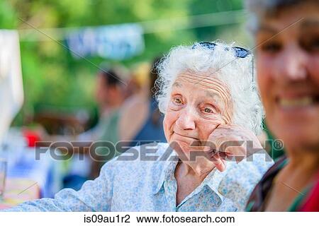 Senior woman daydreaming at tomato eating festival View Large Photo Image Stock Image - Senior woman daydreaming at tomato eating festival. Fotosearch