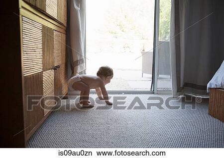 Side view of baby boy on all fours in front of patio doors View Large Photo Image Picture - Side view of baby boy on all fours in front of patio doors. Fotosearch