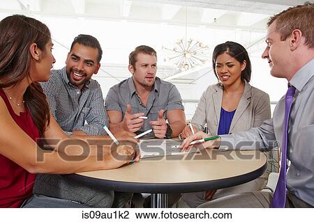 Stock Image - Small group of people having brainstorming business meeting. Fotosearch