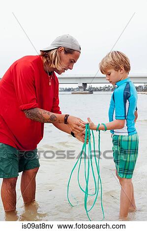 Teacher showing boy how to use cast net, Sanibel Island, Pine Island Sound, Florida, USA View Large Photo Image Stock Photo - Teacher showing boy how to use cast net, Sanibel Island, Pine Island Sound, Florida, USA. Fotosearch