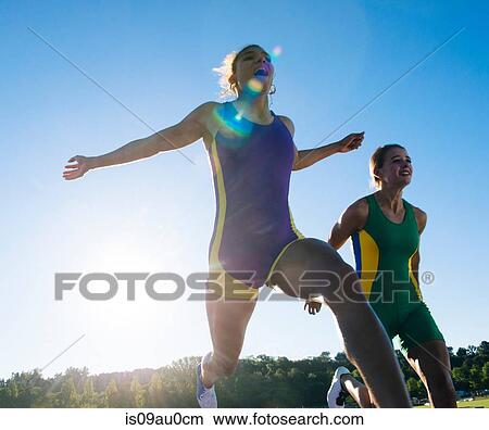 Two female athletes on athletics track, at end of race View Large Photo Image Picture - Two female athletes on athletics track, at end of race. Fotosearch