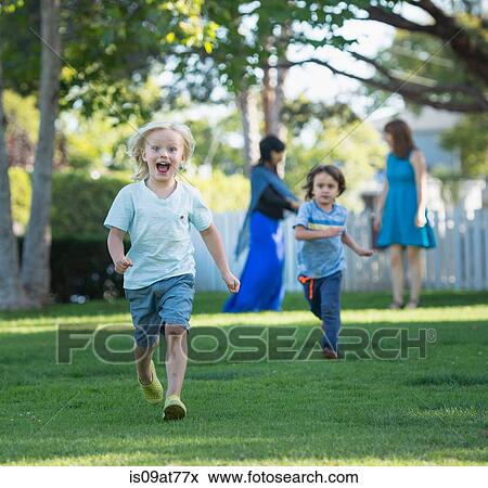 Two young boys having race in garden View Large Photo Image Stock Photo - Two young boys having race in garden. Fotosearch