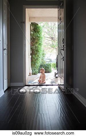 View through entrance hall of baby boy sitting outside at open front door, looking at camera open mouthed View Large Photo Image Stock Image - View through entrance hall of baby boy sitting outside at open front door, looking at camera open mouthed. Fotosearch