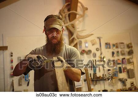 Wood artist in workshop, measuring wood View Large Photo Image Stock Image - Wood artist in workshop, measuring wood. Fotosearch
