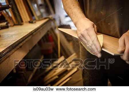 Wood artist in workshop, sanding wood, close-up View Large Photo Image Stock Photo - Wood artist in workshop, sanding wood, close-up. Fotosearch