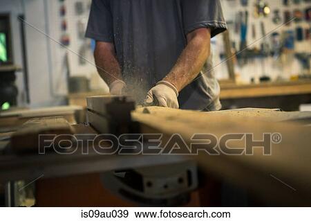 Wood artist in workshop, using woodworking machinery, mid section View Large Photo Image Stock Photo - Wood artist in workshop, using woodworking machinery, mid section. Fotosearch