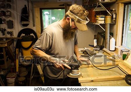 Wood artist working in workshop, using machinery View Large Photo Image Stock Photograph - Wood artist working in workshop, using machinery. Fotosearch