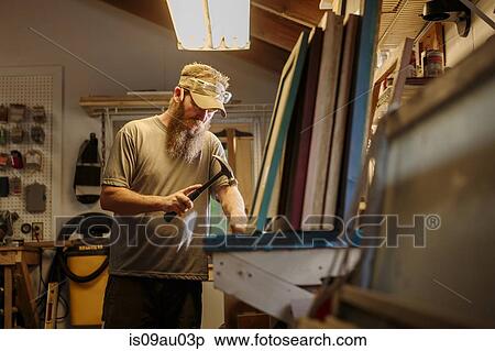 Wood artist working in workshop, using hammer View Large Photo Image Stock Photography - Wood artist working in workshop, using hammer. Fotosearch