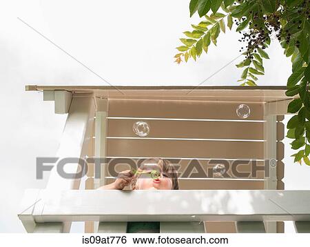 Young boy blowing bubbles, outdoors, low angle view View Large Photo Image Stock Photograph - Young boy blowing bubbles, outdoors, low angle view. Fotosearch