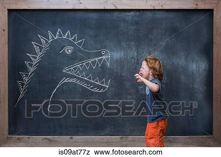 Young boy roaring at dinosaur drawing on blackboard View Large Photo Image Stock Photo - Young boy roaring at dinosaur drawing on blackboard. Fotosearch
