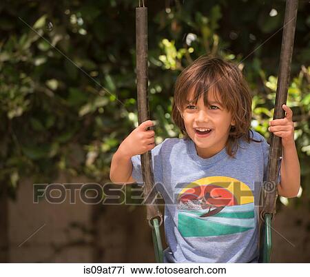 Young boy swinging on garden swing View Large Photo Image Stock Image - Young boy swinging on garden swing. Fotosearch
