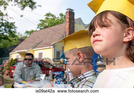 Stock Image - Young children at kindergarten graduation. Fotosearch