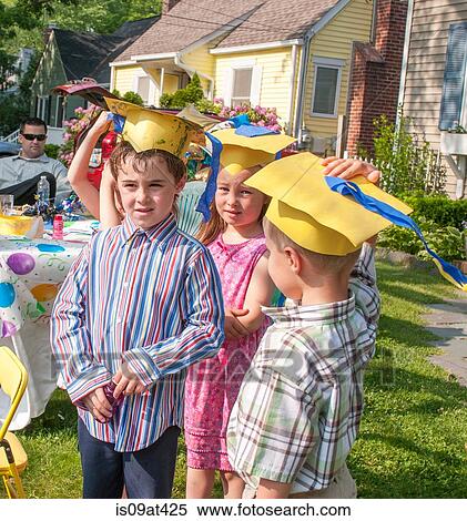 Young children at kindergarten graduation, wearing paper mortar boards View Large Photo Image Stock Photography - Young children at kindergarten graduation, wearing paper mortar boards. Fotosearch