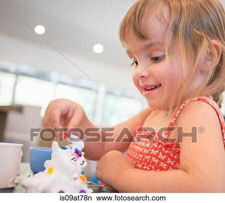 Young girl playing messy play at table View Large Photo Image Picture - Young girl playing messy play at table. Fotosearch