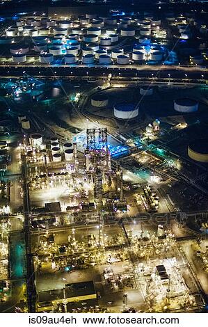 Aerial view of oil refinery and storage tanks illuminated at night, Los Angeles, California, USA View Large Photo Image Stock Image - Aerial view of oil refinery and storage tanks illuminated at night, Los Angeles, California, USA. Fotosearch