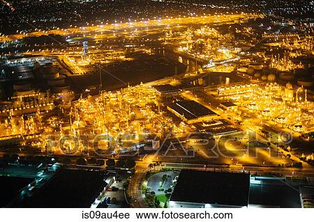 Stock Image - Aerial view of oil refinery illuminated at night, Los Angeles, California, USA. Fotosearch
