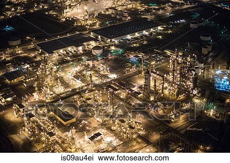 Stock Image - Aerial view of oil refinery illuminated at night, Los Angeles, California, USA. Fotosearch