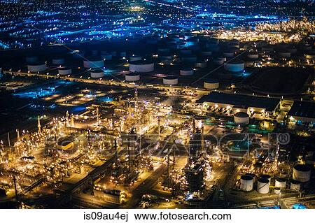 Stock Image - Aerial view of oil refinery illuminated at night, Los Angeles, California, USA. Fotosearch