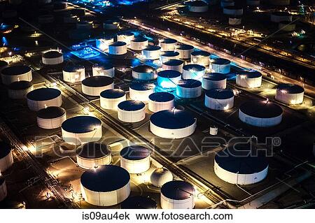 Aerial view of oil refinery storage tanks illuminated at night, Los Angeles, California, USA View Large Photo Image Stock Image - Aerial view of oil refinery storage tanks illuminated at night, Los Angeles, California, USA. Fotosearch
