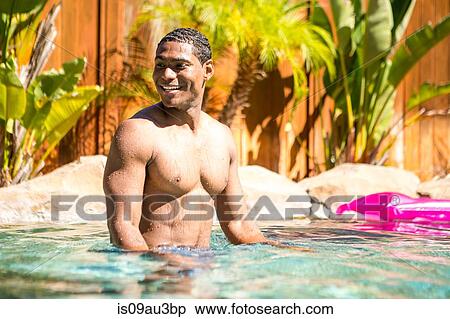 Bare chested mid adult man in swimming pool looking away smiling View Large Photo Image Stock Photography - Bare chested mid adult man in swimming pool looking away smiling. Fotosearch
