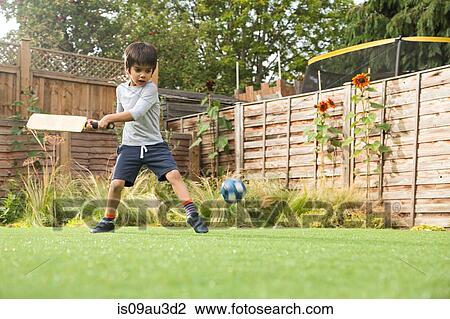 Boy playing cricket in garden, ball in mid air View Large Photo Image Stock Image - Boy playing cricket in garden, ball in mid air. Fotosearch