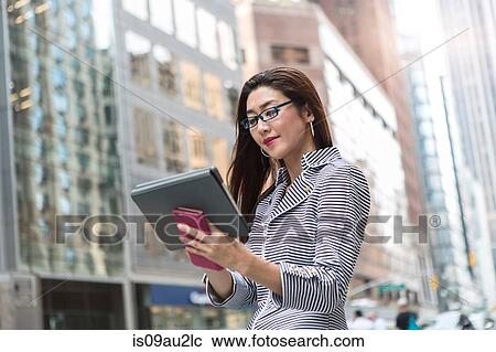 Businesswoman using digital tablet on street View Large Photo Image Stock Image - Businesswoman using digital tablet on street. Fotosearch