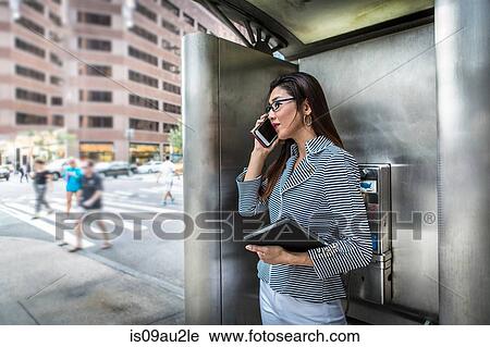 Businesswoman using smartphone on street View Large Photo Image Stock Image - Businesswoman using smartphone on street. Fotosearch
