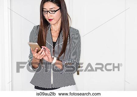 Businesswoman using smartphone View Large Photo Image Stock Image - Businesswoman using smartphone. Fotosearch