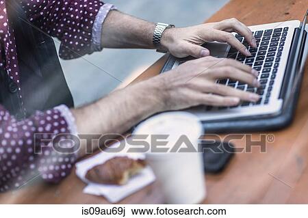 Cropped view of young businessman typing on laptop keyboard at sidewalk cafe View Large Photo Image Stock Image - Cropped view of young businessman typing on laptop keyboard at sidewalk cafe. Fotosearch