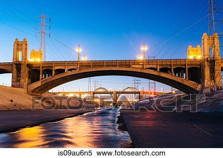 Stock Photography - Diminishing perspective of Los Angeles river and 4th and 6th street bridges in the evening, Los Angeles, California, USA. Fotosearch