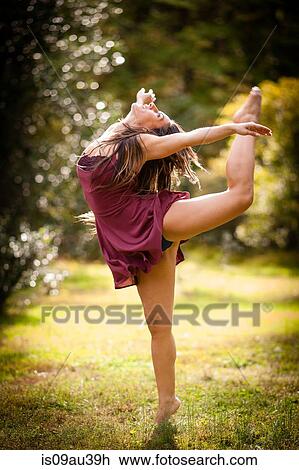 Full length side view of mid adult woman wearing short dress dancing on grass, head back, arms open, leg raised View Large Photo Image Stock Image - Full length side view of mid adult woman wearing short dress dancing on grass, head back, arms open, leg raised. Fotosearch