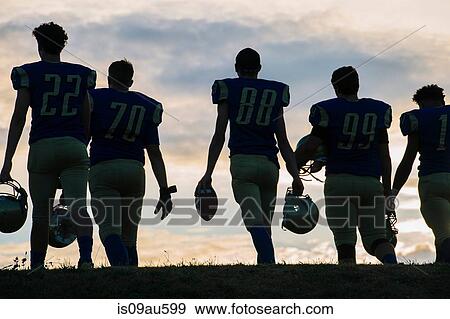 Stock Photo - Group of young american football players walking away, rear view. Fotosearch