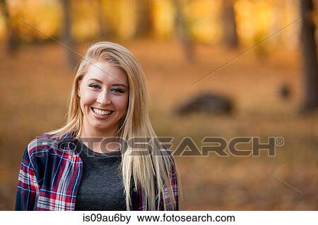 Head and shoulder portrait of young woman with long blond hair in autumn forest View Large Photo Image Stock Photo - Head and shoulder portrait of young woman with long blond hair in autumn forest. Fotosearch