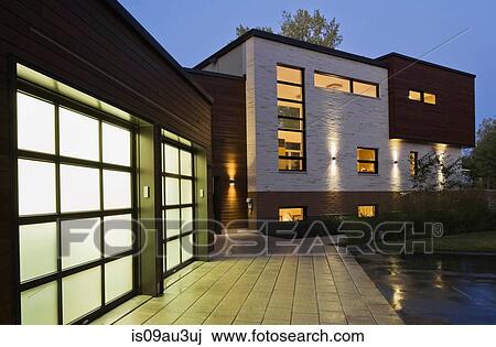 Illuminated two car garage of modern cubist style residential home at dusk, Quebec, Canada View Large Photo Image Stock Image - Illuminated two car garage of modern cubist style residential home at dusk, Quebec, Canada. Fotosearch
