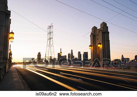 Stock Image - Light trails of traffic crossing 4th street bridge in the evening, Los Angeles, California, USA. Fotosearch