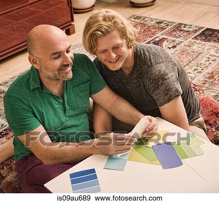 Male couple sitting on floor choosing color swatch View Large Photo Image Stock Photo - Male couple sitting on floor choosing color swatch. Fotosearch