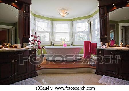 Master bedroom en suite with freestanding bathtub, cottage style home, Quebec, Canada View Large Photo Image Stock Photo - Master bedroom en suite with freestanding bathtub, cottage style home, Quebec, Canada. Fotosearch