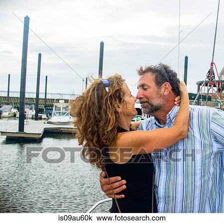 Mature couple in marina nose to nose smiling View Large Photo Image Stock Image - Mature couple in marina nose to nose smiling. Fotosearch