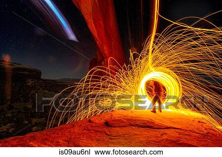 Mature man creating long exposure light painting on cliff side, Moab, Utah, USA View Large Photo Image Stock Image - Mature man creating long exposure light painting on cliff side, Moab, Utah, USA. Fotosearch