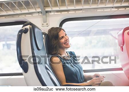 Mid adult woman on train, smiling View Large Photo Image Stock Image - Mid adult woman on train, smiling. Fotosearch