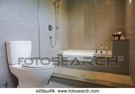 Modern bathroom with bath tub, toilet and glass shower screen View Large Photo Image Stock Image - Modern bathroom with bath tub, toilet and glass shower screen. Fotosearch