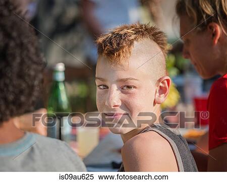 Portrait of boy with mohawk looking over shoulder at camera smiling View Large Photo Image Stock Photography - Portrait of boy with mohawk looking over shoulder at camera smiling. Fotosearch