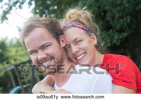 Portrait of couple hugging looking at camera smiling View Large Photo Image Stock Photo - Portrait of couple hugging looking at camera smiling. Fotosearch